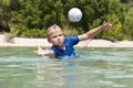 Diving for a ball in a lake Royalty Free Stock Photo