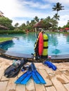 Professional diving equipment lying on the edge of swimming pool at tropical hotel resort Royalty Free Stock Photo