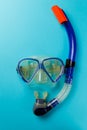 Diving equipment. Snorkeling mask and tube on blue background. Colorful background. Top view. Copy space Royalty Free Stock Photo