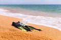 diving goggles, snorkel and fins on the beach with yellow sand. close-up of snorkeling equipment, against the backdrop Royalty Free Stock Photo