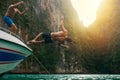 Diving into holiday mode. a young man doing a backflip off a boat while his friends watch. Royalty Free Stock Photo