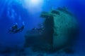 A diving instructor leads a group of divers through a big shipwreck Royalty Free Stock Photo