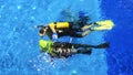 Diving instructor and students. Instructor teaches students to dive in the swimming pool. Scuba diving school concept Royalty Free Stock Photo