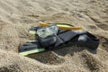 A diving mask, fins and a snorkel on a sandy rocky beach Royalty Free Stock Photo