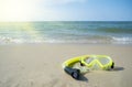 Diving mask and a snorkel on the sand of a beach