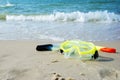 Diving mask and a snorkel on the sand of a beach