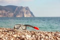 Diving mask on stone beach with beautiful mountain and sea background. Copy space Royalty Free Stock Photo