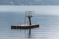 A diving platform in Walenstadt, Switzerland, with Mols in the background Royalty Free Stock Photo