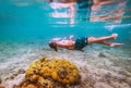 Diving teenage boy snorkeling in underwater glasses making bubbles over the coral reefs underwater photo in the clean turquoise Royalty Free Stock Photo