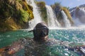 Diving under the waterfall of the Krka River