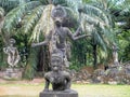 Divinity sculpture in Xieng Khuan Buddha Park Laos surrounded by vegetation