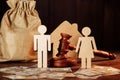 The division of property and divorce concept. Bag of money, house, people and the judge's hammer Royalty Free Stock Photo