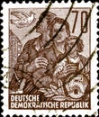 02 11 2020 Divnoe Stavropol Territory Russia postage stamp GDR 1955 - Five-Year Plan man woman child and the dove Royalty Free Stock Photo