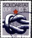 02.11.2020 Divnoe Stavropol Territory Russia postage stamp GDR 1984 Solidarites bound knot and red star above it on the gray