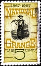 02 08 2020 Divnoe Stavropol Territory Russia postage stamp USA 1967 National Grange Centenary Grange Poster, 1870 man with a