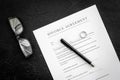 Divorce agreement. Wedding ring on document on black background top view Royalty Free Stock Photo