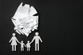 Divorce concept. Broken plate pieces and paper cutout of family on black background, flat lay with space for text Royalty Free Stock Photo