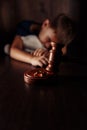 Divorce concept. Wooden gavel, rings and frustrated little boy with teddy bear. Family divorce effect on children