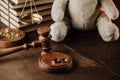 Divorce concept. Wooden gavel, rings and teddy bear as symbol of child on a desk Royalty Free Stock Photo