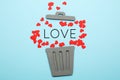 Divorce of couple, red hearts in trash can. Love and hatred, separation
