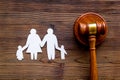 Divorce court concept. Judge gavel near family on dark wooden background top-down