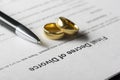 Divorce decree form with marriage ring and pen Royalty Free Stock Photo