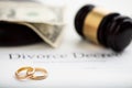 Divorce decree, gavel and wedding rings. Royalty Free Stock Photo