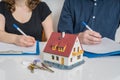 Divorce and dividing a property concept. Man and woman are signing divorce agreement Royalty Free Stock Photo