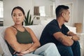 Divorce, fight or arms crossed couple on sofa for anxiety, fear or frustrated by liar, stress or drama at home. Marriage Royalty Free Stock Photo