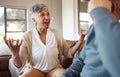 Divorce, fight and senior couple on a sofa angry, shouting and frustrated in their home together. Marriage, crisis and Royalty Free Stock Photo