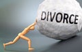 Divorce and painful human condition, pictured as a wooden human figure pushing heavy weight to show how hard it can be to deal Royalty Free Stock Photo