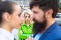 Divorce reason. Infidelity. Disloyal man walking with his girlfriend and looking amazed at another seductive girl Royalty Free Stock Photo