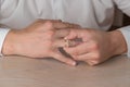 Divorce, separation: man removing wedding or engagement ring