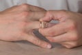 Divorce, separation: man removing wedding or engagement ring