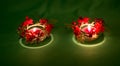 Diwali. Burning candles decorated with bright red flowers on a green background. Deepavali celebration of light and fire.