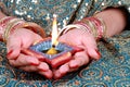 Diwali Celebration Diya Light on a Female Hand