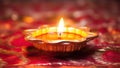 Diwali diya or oil lamp on colorful rangoli background