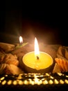 Diwali diyas in candel form, arranged beautifully on sea shells and golden plate