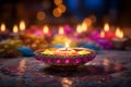 Diwali glowing Diya or oil lamp over colorful Rangoli background - Ai Generated