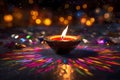 Diwali glowing Diya or oil lamp over colorful Rangoli background - Ai Generated