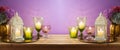 Diwali holiday concept with lantern, candles and flowers decoration on wooden table over purple background