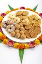 Homemade snacks with flowers kept with rangoli Royalty Free Stock Photo