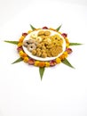 Homemade snacks with flowers kept with rangoli Royalty Free Stock Photo