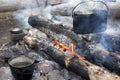 A dixy on the fire is on stones in the forest Royalty Free Stock Photo