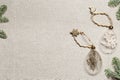Diy baubles filled dried florals, grass. Glass Christmas ornaments on rustic cloth texture background. New Year holiday