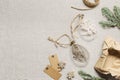 Diy baubles filled dried florals, grass. Glass Christmas ornaments on rustic cloth texture background. New Year holiday