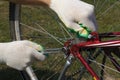 DIY bike repair. Close-up image of cyclist`s hand repairs wheel of bicycle