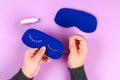 Diy blue felt sleep mask with white thread embroidered with closed eyes with eyelashes on gum