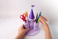 DIY cardboard castle craft in the form of a stand for school items made from empty rolls of toilet paper, simple idea Royalty Free Stock Photo