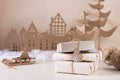 DIY Christmas home decor - a stack of gifts in craft paper, a cardboard tree and a house. Handmade